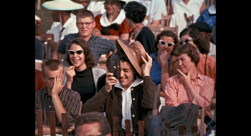 Woman with a movie camera in a crowd