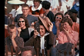 Woman with a movie camera in a crowd